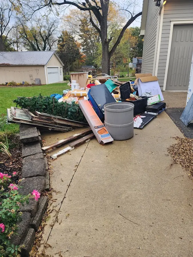 Dumpster being loaded with debris for 12 Yard Dumpster Rental in Jonesborough